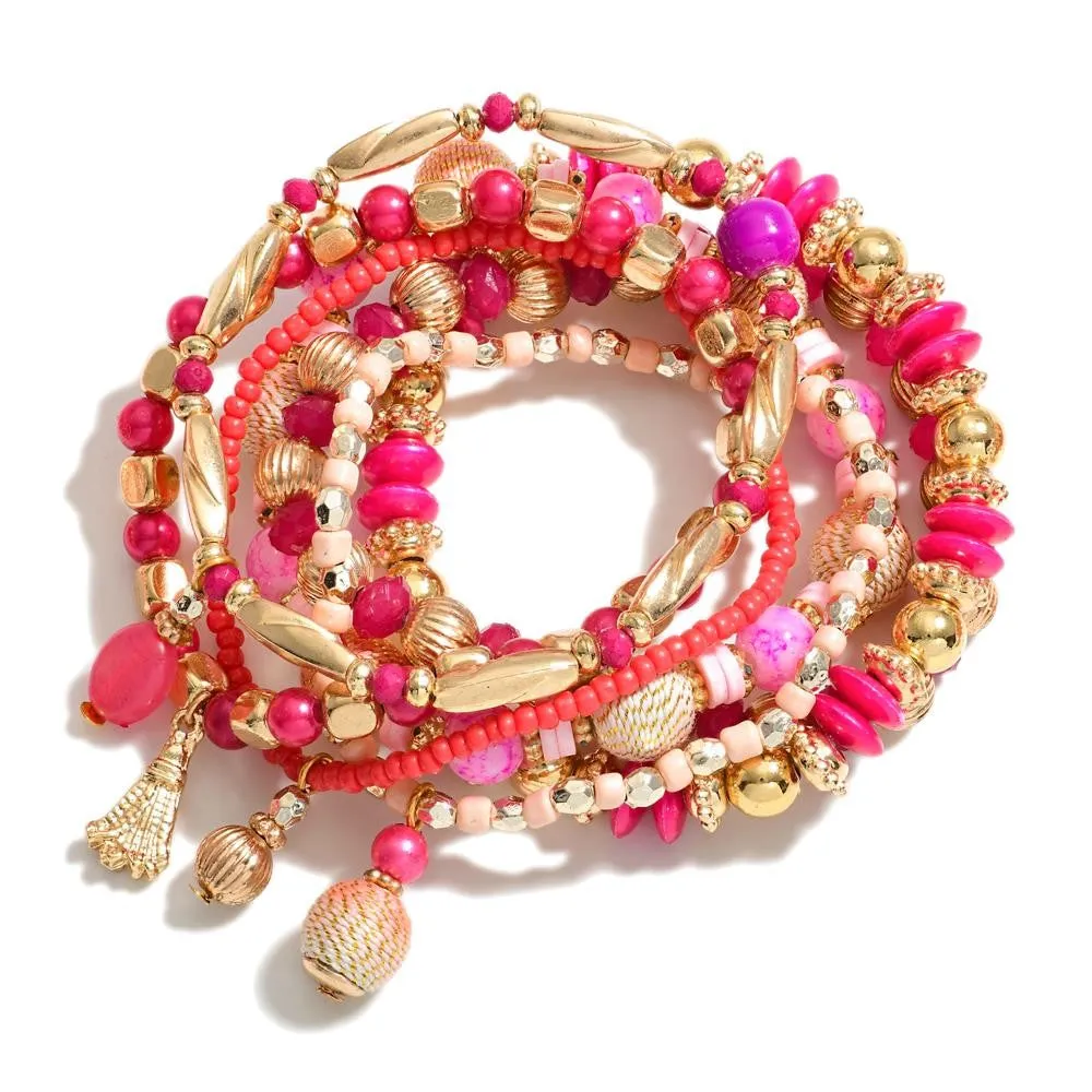 Pink Set of Seven Beaded Stretch Bracelets Featuring Gold Tones And Metallic Rope Wrapped Beads